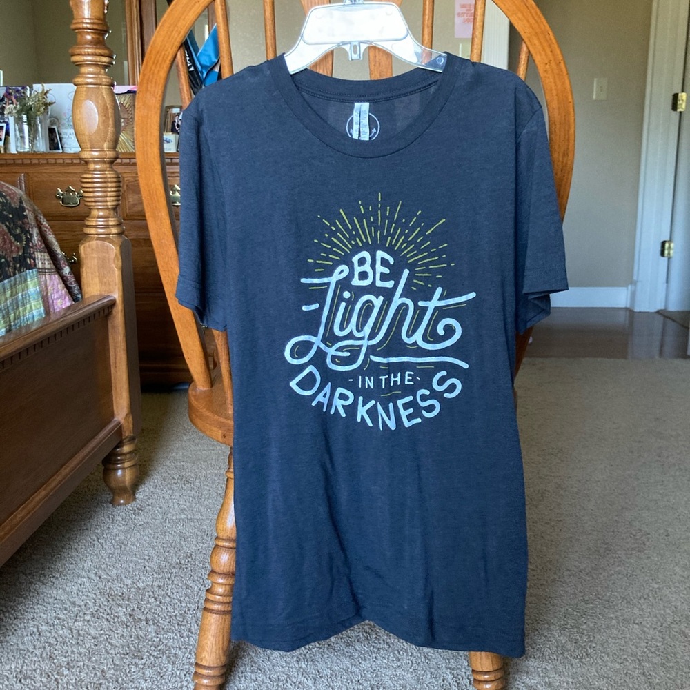 “be light in the darkness” tee